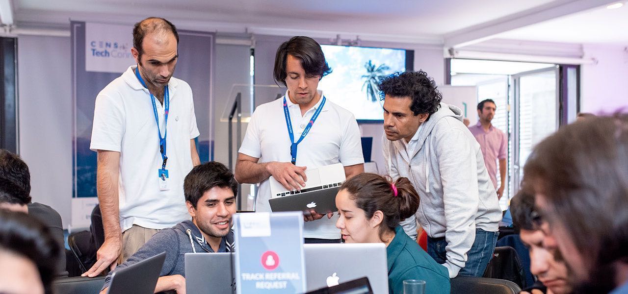 5 personas trabajando en tecnología con sus computadores